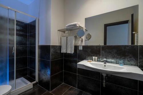 a bathroom with a sink and a shower at Hotel Cristallo in Rimini