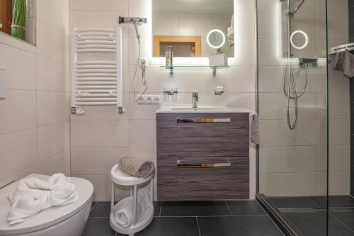 a white bathroom with a sink and a toilet at Haus am Lift in Kappl