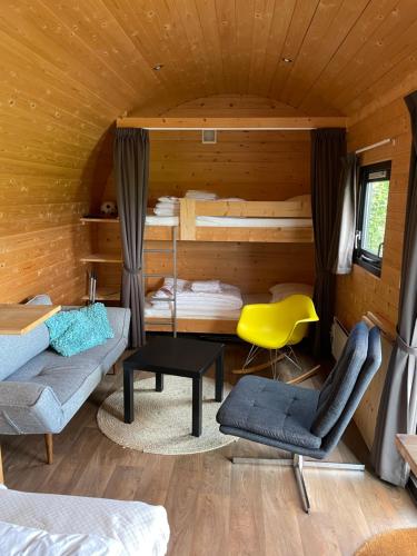 a room with a bed and a couch and a table at Woodlodge Menaldum in Dronrijp
