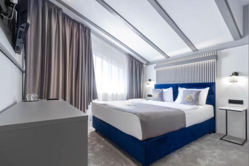 a bedroom with a large bed and a window at Kayus in Buşteni