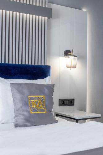 a bedroom with a bed with a blue head board at Kayus in Buşteni