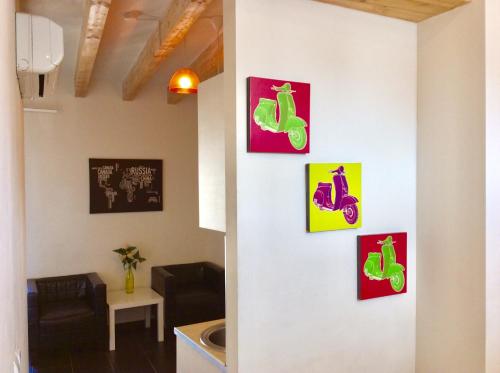 a wall with four pictures of green shoes on it at Santa Barbara Guesthouse in Alicante
