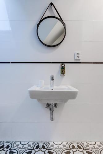 a bathroom with a white sink and a mirror at Design Pension Twenty 20 in Poděbrady