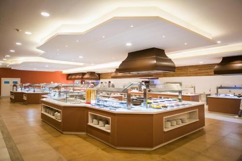 a restaurant kitchen with a lot of food at Majestic Mirage Punta Cana, All Suites – All Inclusive in Punta Cana