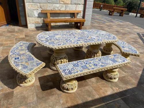 a table and two benches sitting on a patio at Casa Rural Mugarri in Poveña