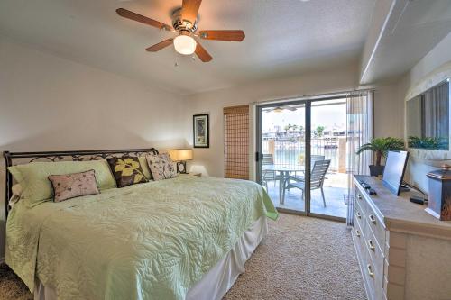 a bedroom with a bed and a ceiling fan at Havasu Condo with View of Lake and London Bridge! in Lake Havasu City
