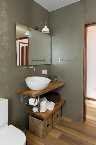 a bathroom with a sink and a mirror at Casitas de Madera O Loureiro in Noya