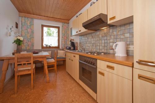 a kitchen with a table and a dining room at Ferienwohnungen Schneider in Kirchdorf in Tirol