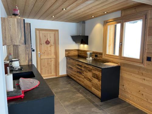 a kitchen with a counter and a window at Chalet Serre Chevalier in Le Monêtier-les-Bains