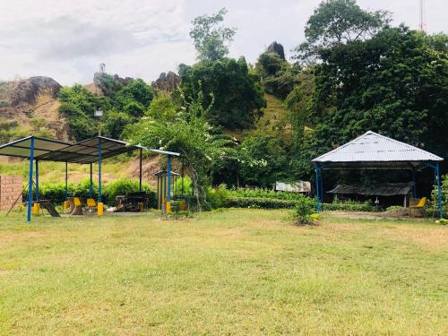 a park with a pavilion and a building with a field at Hotel Casa Vieja in Ortega