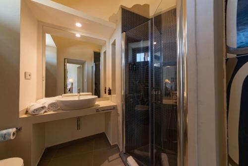 a bathroom with a sink and a shower at Insula Boutique Hotel in Procida