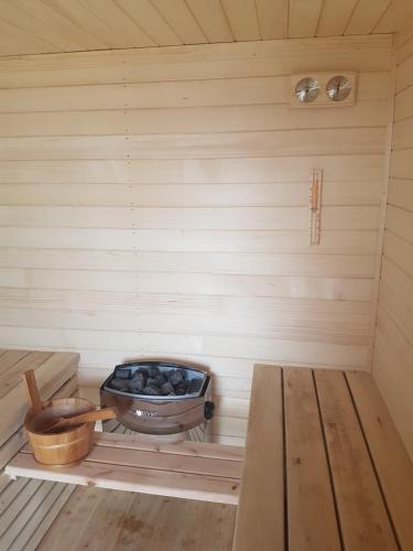 a inside of a sauna with a bowl of charcoal at Domek pod chałpom sauna & bania in Gliczarów