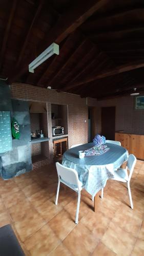 a table and two chairs in a living room at Adega do Gato in Calhau
