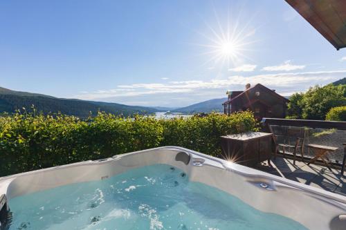 a jacuzzi tub with a view of the water at Åre Travel - Tottbacken in Åre