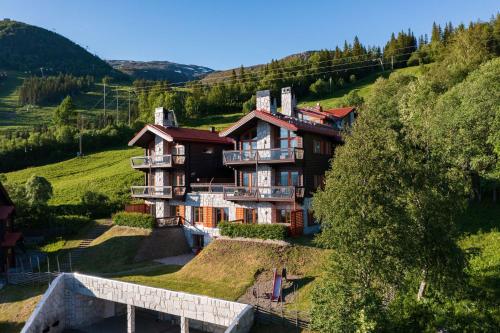 a large house on a hill with a bridge at Åre Travel - Tottbacken in Åre