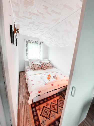 a small bedroom with a bed and a rug at Holiday Home CASTLE in Bihać