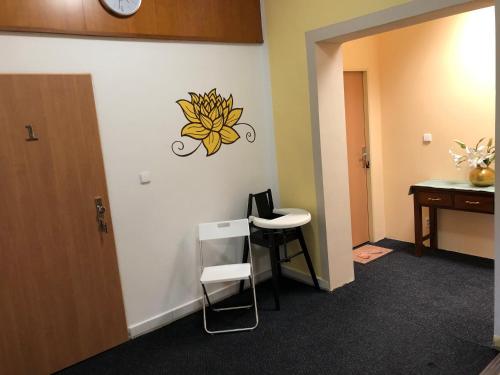 a room with a desk and a chair and a clock on the wall at DNM Inn in Koryčany