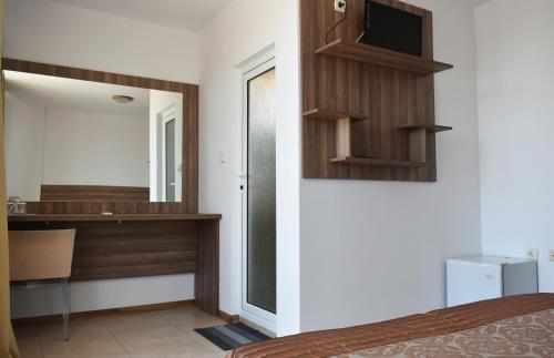 a bedroom with a bed and a mirror and a desk at Time out in Sozopol