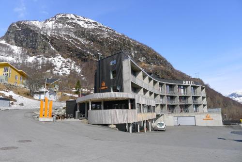 a large building in front of a mountain at Hordatun Apartments in Røldal