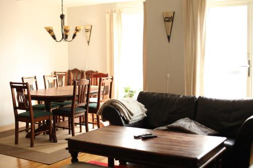 a living room with a couch and a table and chairs at Hordatun Apartments in Røldal