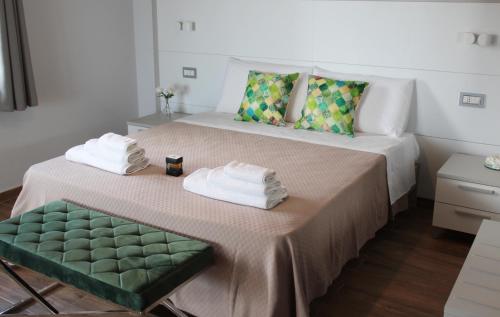 een slaapkamer met een bed met handdoeken erop bij Thalasso Rooms B&B in Cirella