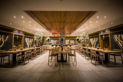 a restaurant with long tables and chairs and lights at Majestic Mirage Punta Cana, All Suites – All Inclusive in Punta Cana