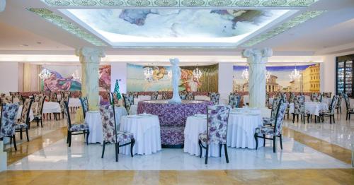 a banquet hall with tables and chairs and a ceiling at Majestic Mirage Punta Cana, All Suites – All Inclusive in Punta Cana