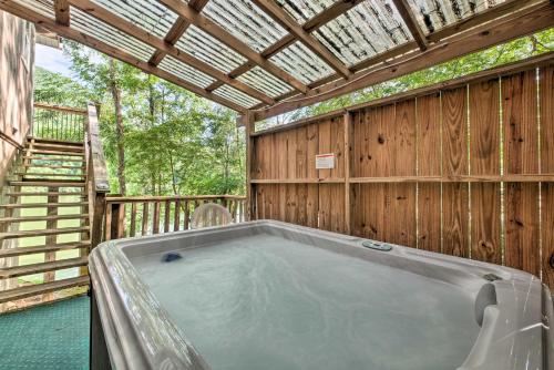 a jacuzzi tub in a wooden house at Cozy Cabin on Tenn River - 10 Mi to Chattanooga! in Chattanooga