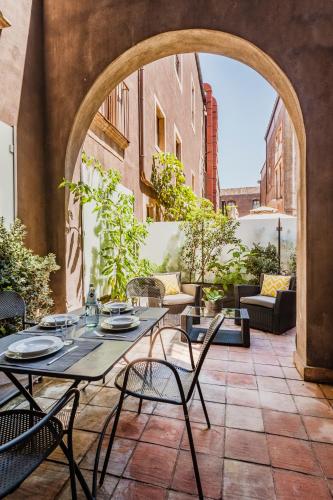 an outdoor patio with a table and chairs at Ferrini Home - Via Monte Sant'Agata in Catania