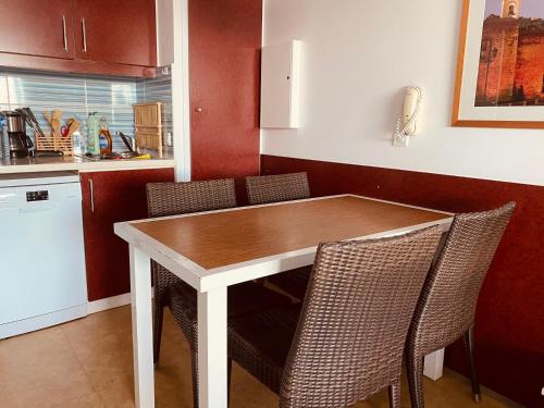 a kitchen with a wooden table and chairs at Sunny Home Costa Plana-Monaco -Cap D'Ail in Cap d'Ail