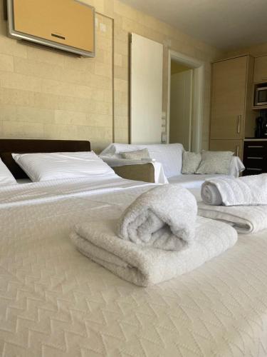 a bedroom with two beds with towels on them at Coquille in Kavála