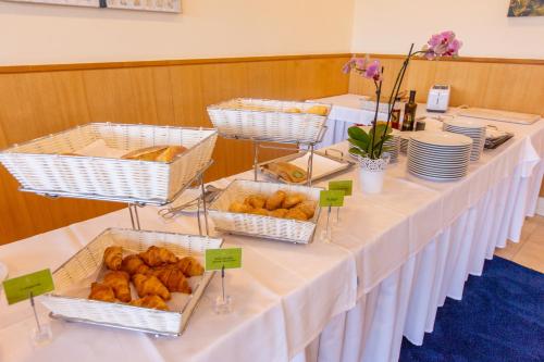 a long table with baskets of pastries on it at MS Vila Nova in Ponta Delgada