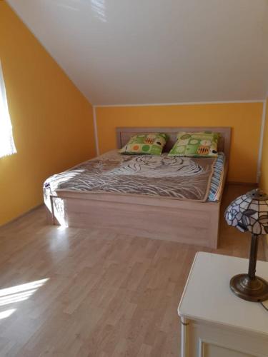 a small bed in a room with yellow walls at Willa Ola in Nadole
