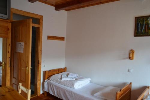 a bedroom with two beds in a room with a door at Pensiunea Muntean in Sibiel