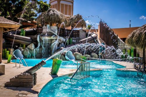 a water slide in a pool with a fountain at Majestic Mirage Punta Cana, All Suites – All Inclusive in Punta Cana