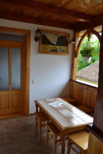 a dining room with a table and a window at Pensiunea Muntean in Sibiel