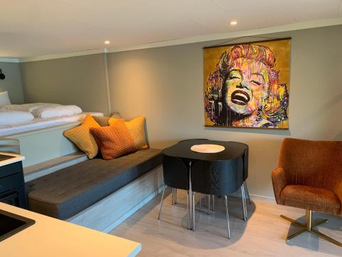 a room with a bed and a table and chairs at Olden Studioapartment in Olden