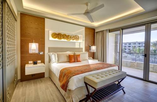 a bedroom with a large bed and a large window at Royalton Bavaro, An Autograph Collection All-Inclusive Resort & Casino in Punta Cana