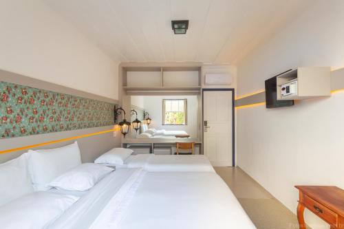 Ein Bett oder Betten in einem Zimmer der Unterkunft Pousada Aconchego