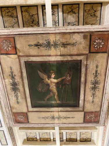 a painting of an angel on the ceiling of a building at Palazzo Forlani in Capranica