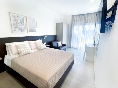 a bedroom with a bed and a chair in it at Sunset Home Sorrento in Sorrento