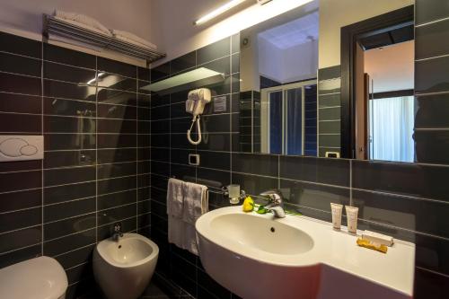 a bathroom with a sink and a mirror at Hotel Cristallo in Rimini