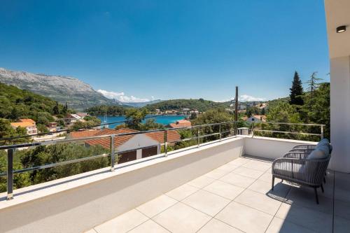 a balcony with a view of a river and mountains at Villa Buddha Bay in Korčula