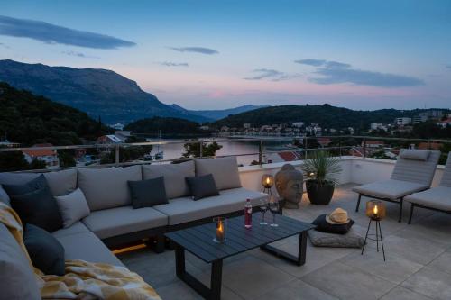 a living room with a couch and a table at Villa Buddha Bay in Korčula