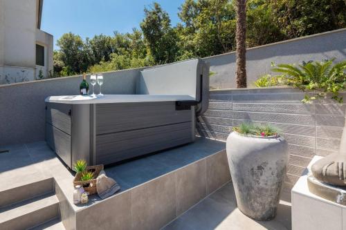 a bath tub sitting on the side of a balcony at Villa Buddha Bay in Korčula