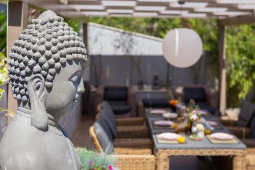a statue of a woman standing in front of a table at Villa Buddha Bay in Korčula