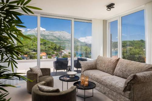 a living room with a couch and a large window at Villa Buddha Bay in Korčula