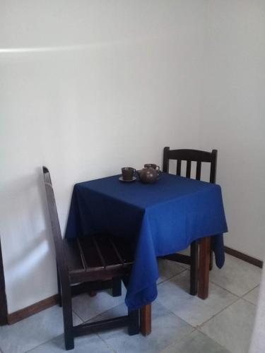 a blue table with a blue table cloth on it at Brisas Del Rio Apart Hotel in Termas del Daymán