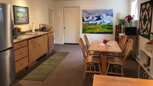 a kitchen with a table and a dining room at Gardenside Bed and Breakfast in Anchorage