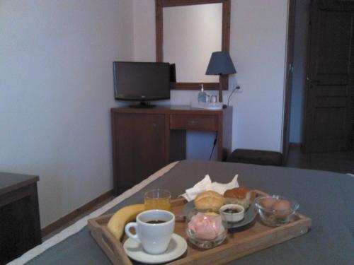 a tray of food on a table in a hotel room at Menta( Archontiko Machalioti ) in Karpenision